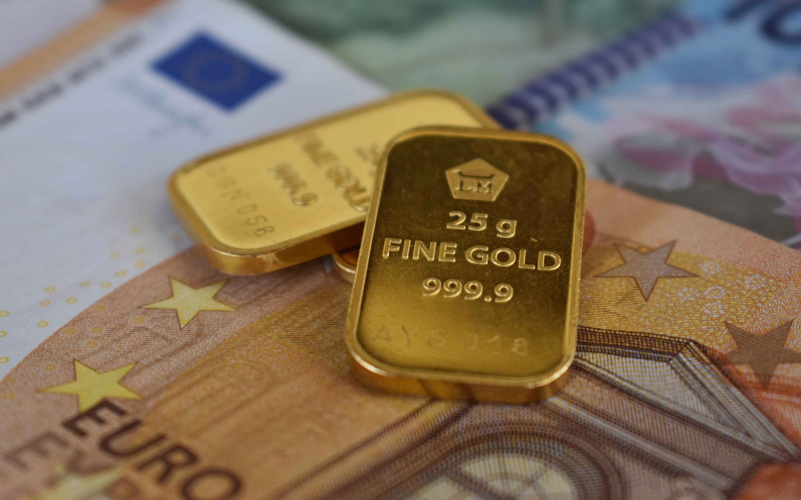 Gold bars resting on banknotes