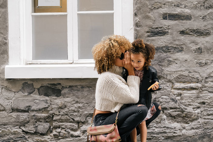 Mother and child outside a classic home